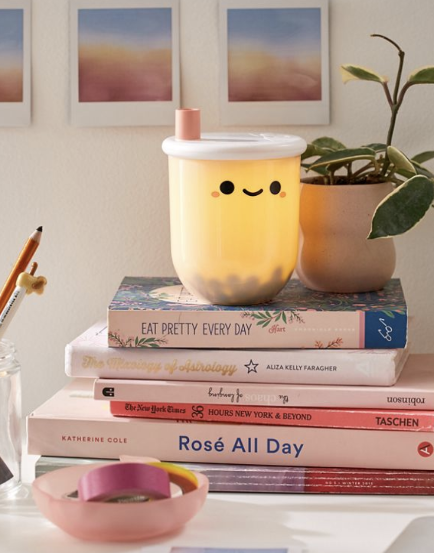 Boba tea-shaped mini lamp on colorful stack of books