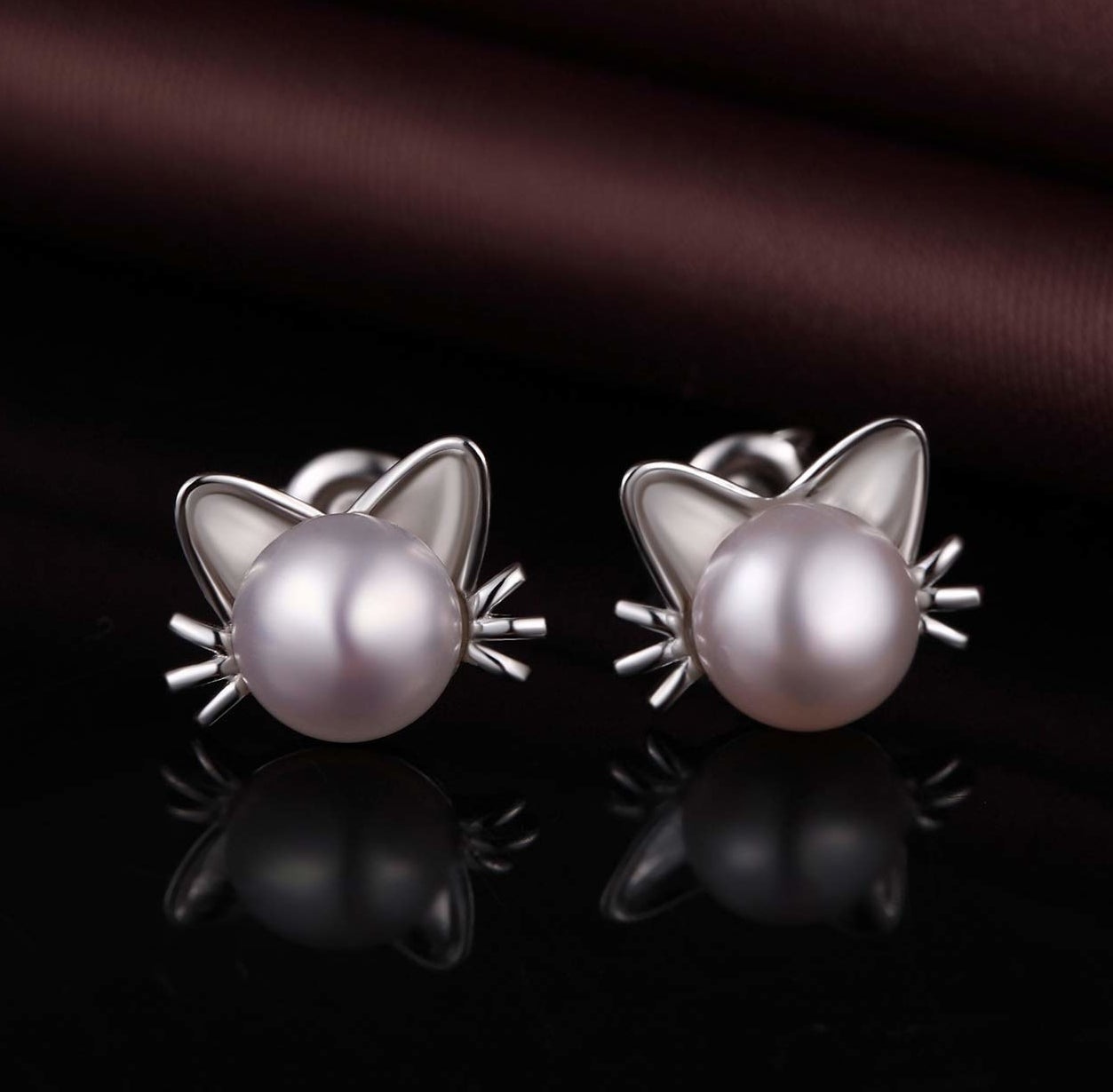 Pearl stud earrings with silver earrings and whiskers