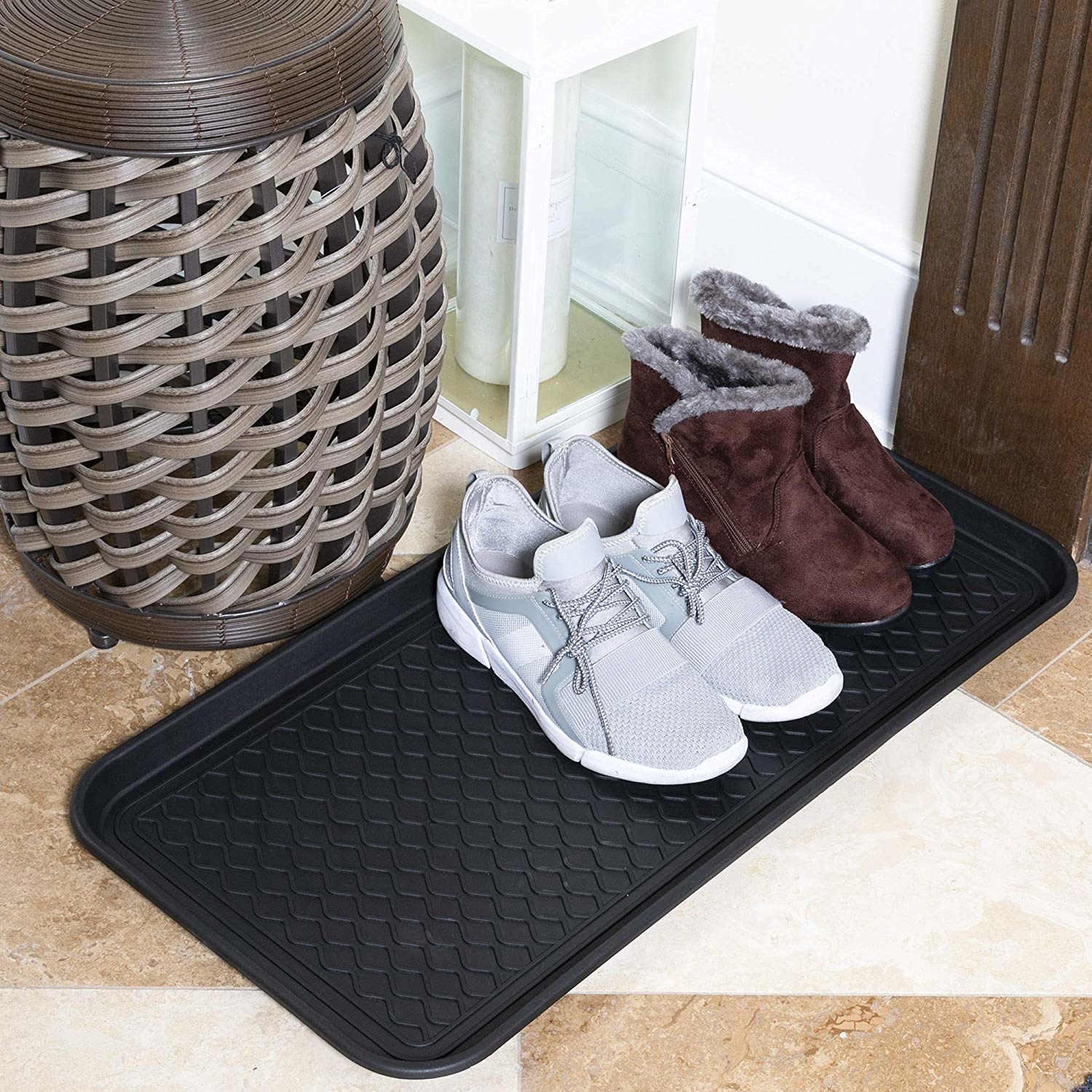 the shoe tray with a pair of sneakers and a pair of boots sitting on them