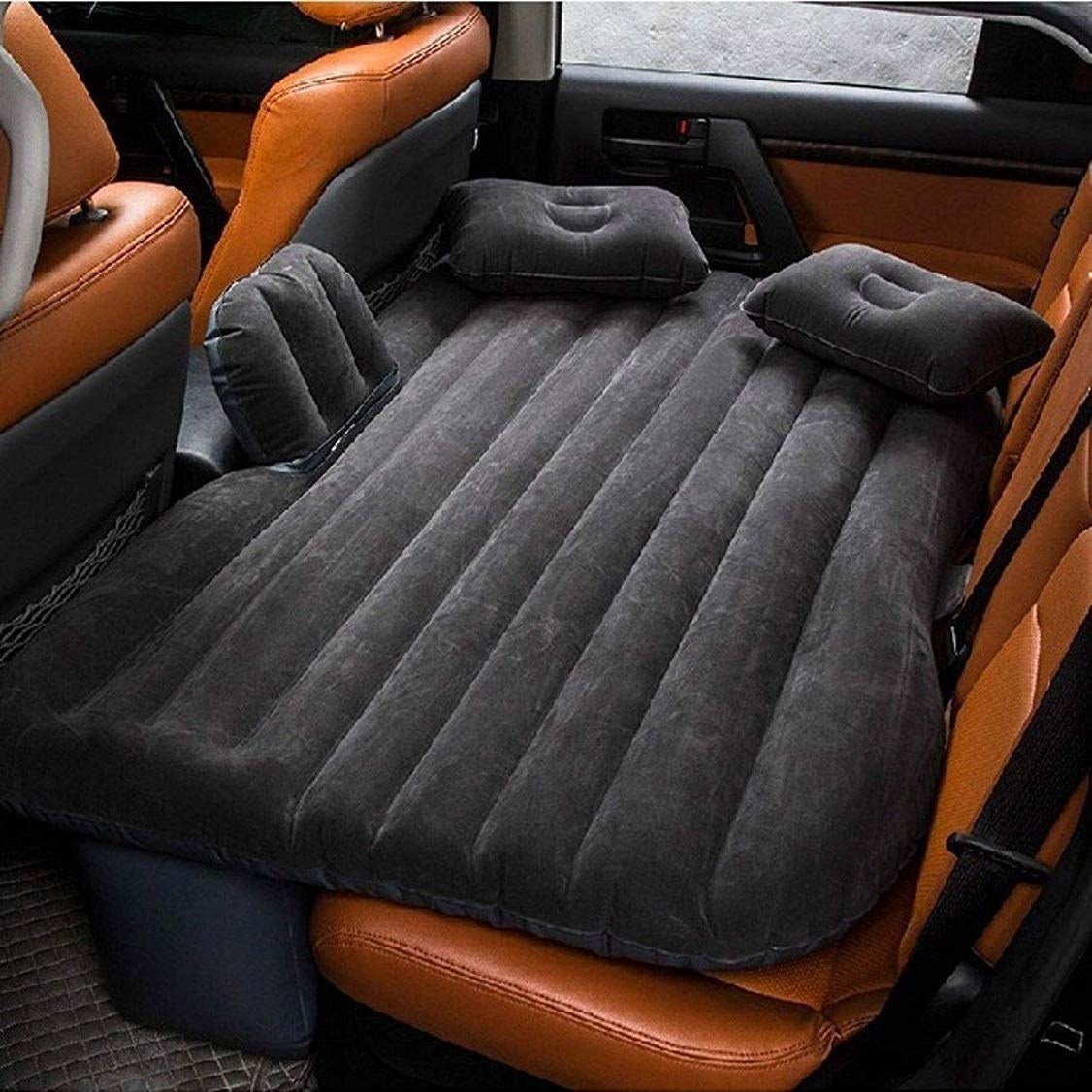Air mattress spread over the backseat of a car.