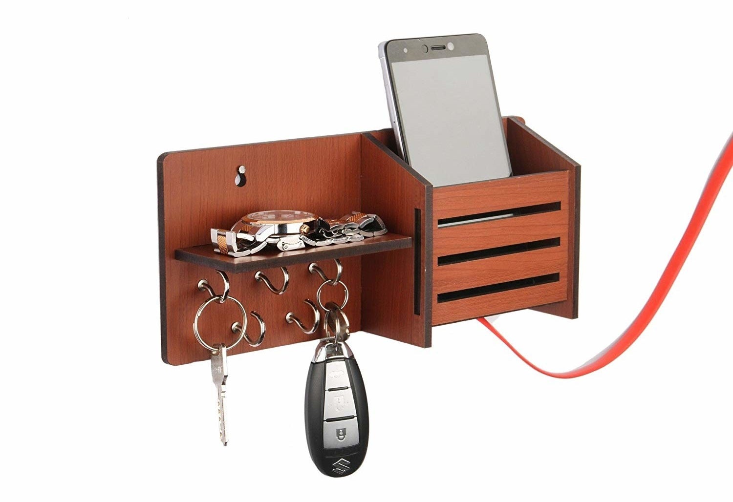 A key holder with keys, a watch, and a phone placed on it