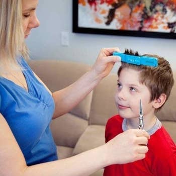 person cutting child's hair using creaclip