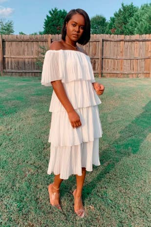 Reviewer wearing the tiered midi dress in white