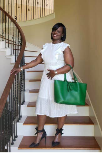 A reviewer wearing the eyelet cap sleeve midi in white