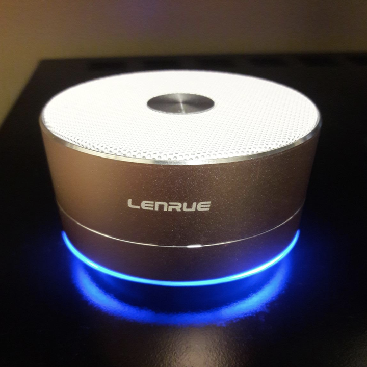 the pink speaker with a light up blue bottom on a shelf