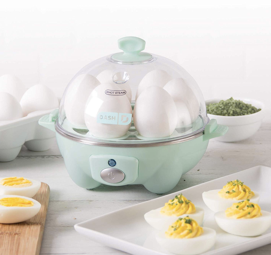 light green Dash Rapid Egg Cooker next to plate of deviled eggs