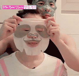 A GIF of two persons using sheet masks.