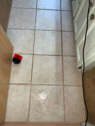 reviewer's photo of in process cleaning the grout of a bathroom floor