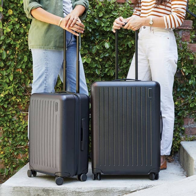 the two different sized Brandless suitcases in black