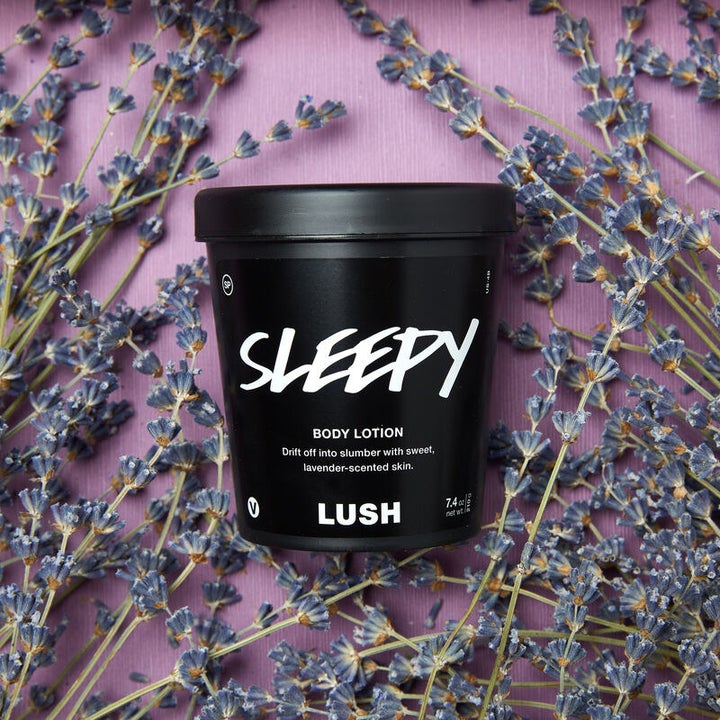 the body lotion on top of a bed of lavender plants