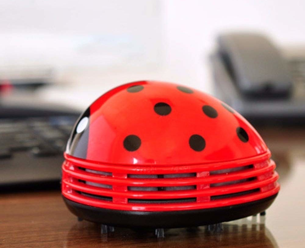 Ladybug-shaped mini vacuum placed on desk