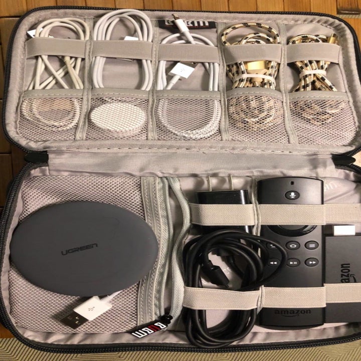 A reviewer showing the case with space on top and the bottom for organizing remotes and cords