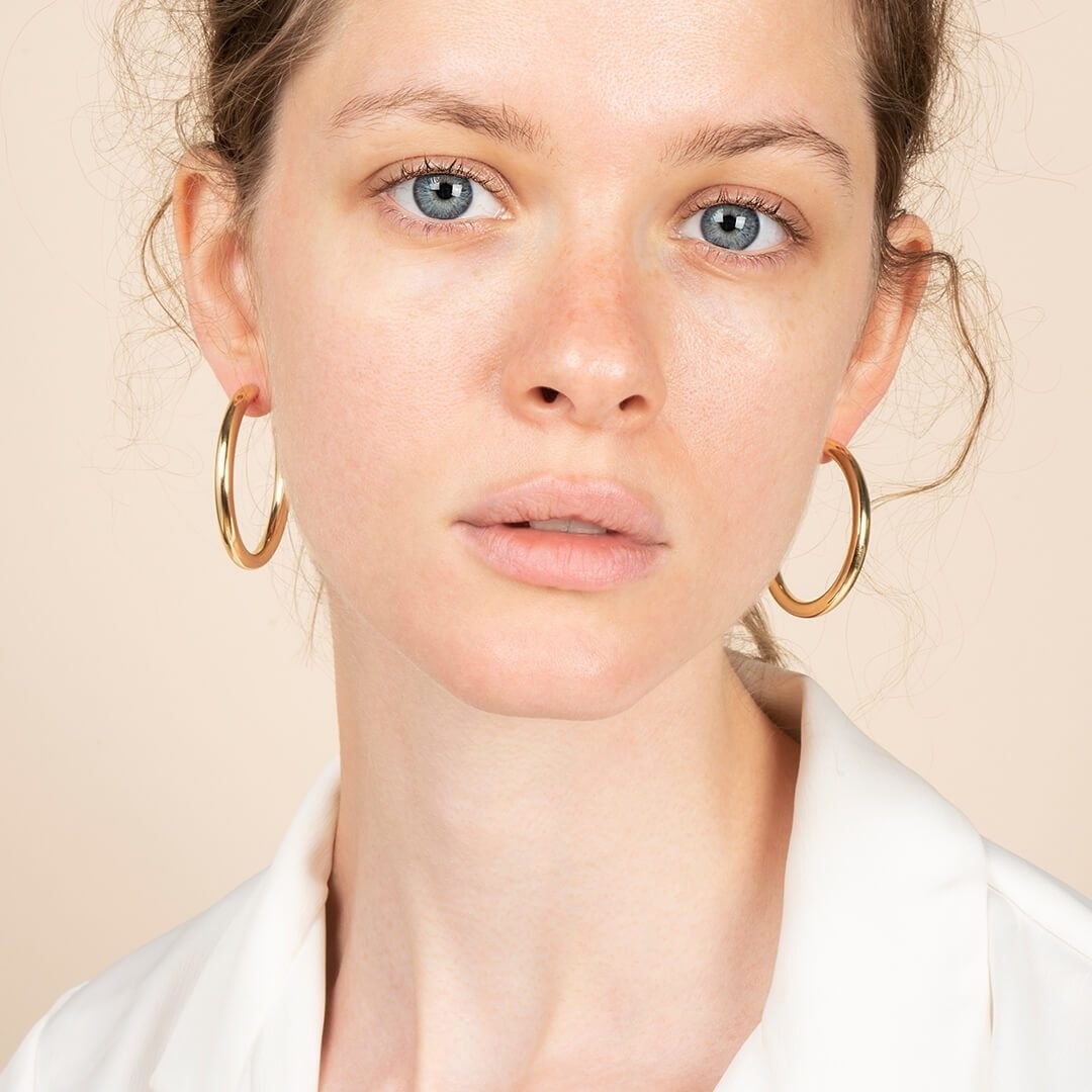 model wearing the gold hoop earrings