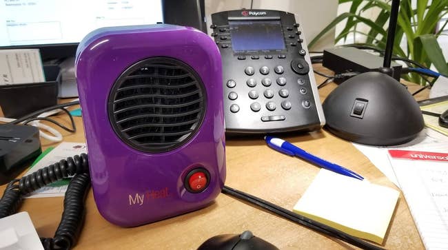 Reviewer photo of mini purple space heater placed on desk
