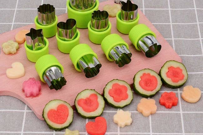 Small fruit and veggies cut from stamps in the shapes of flowers, hearts, and animals 