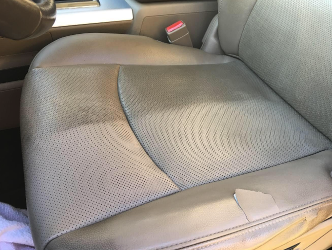 reviewer&#x27;s car seat with half of the gunk removed and the other half still dirty