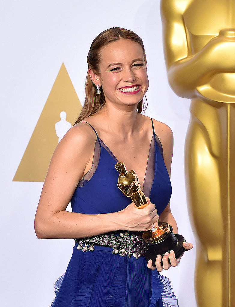 Brie smiling as she holds her award