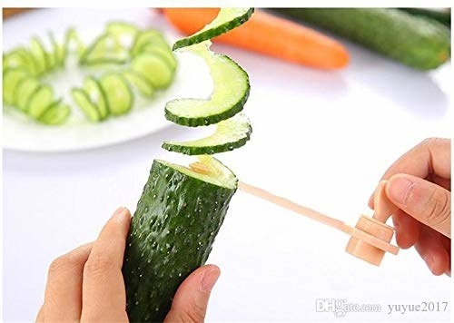 A person slicing through a cucumber using the slicer.