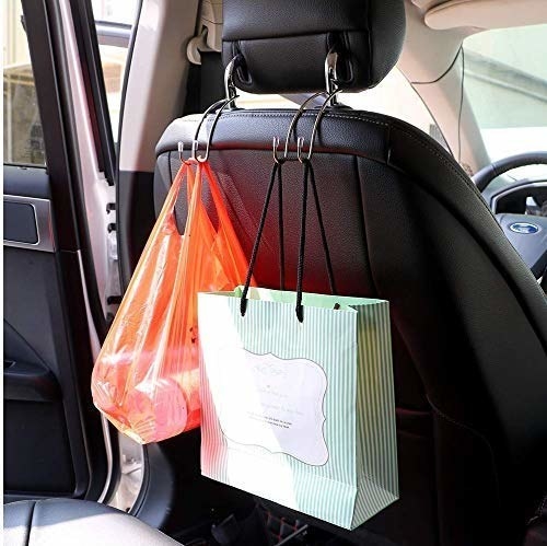 The hooks are attached to the backside of a car seat and are used to hang up shopping bags
