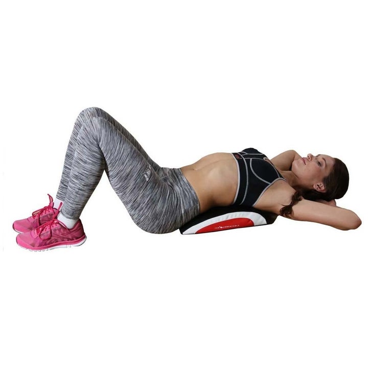 A woman using the ab pad while exercising