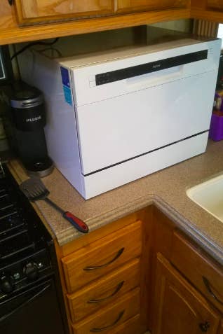 the cube shaped dishwasher on a reviewer's counter
