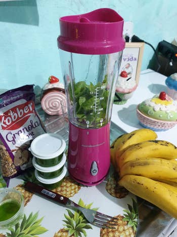 reviewer's pic of the small blender with greens inside it