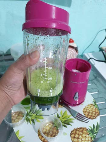 reviewer's pic of a green smoothie in it