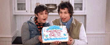 The Lonely Island holding a cake that says, &quot;congrats on the sex&quot;