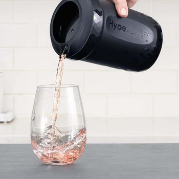 A person pouring cold rosé out of the HyperChiller