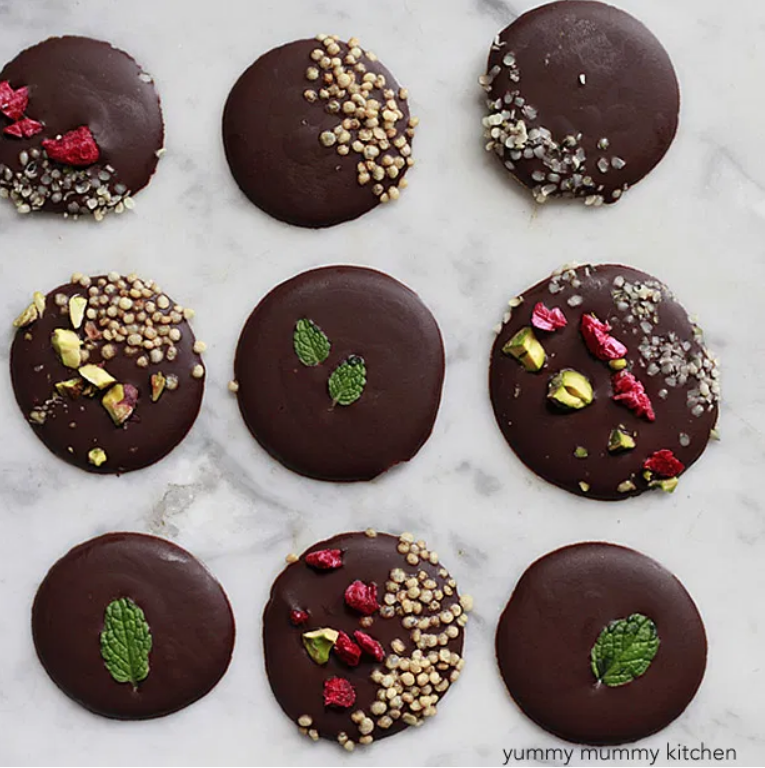 dollops of chocolate frozen with mint, puffed quinoa, goji berries, and hemp seeds on them