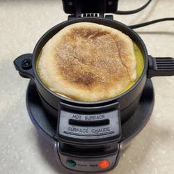 A reviewer image of an English muffin sandwich cooking in the machine