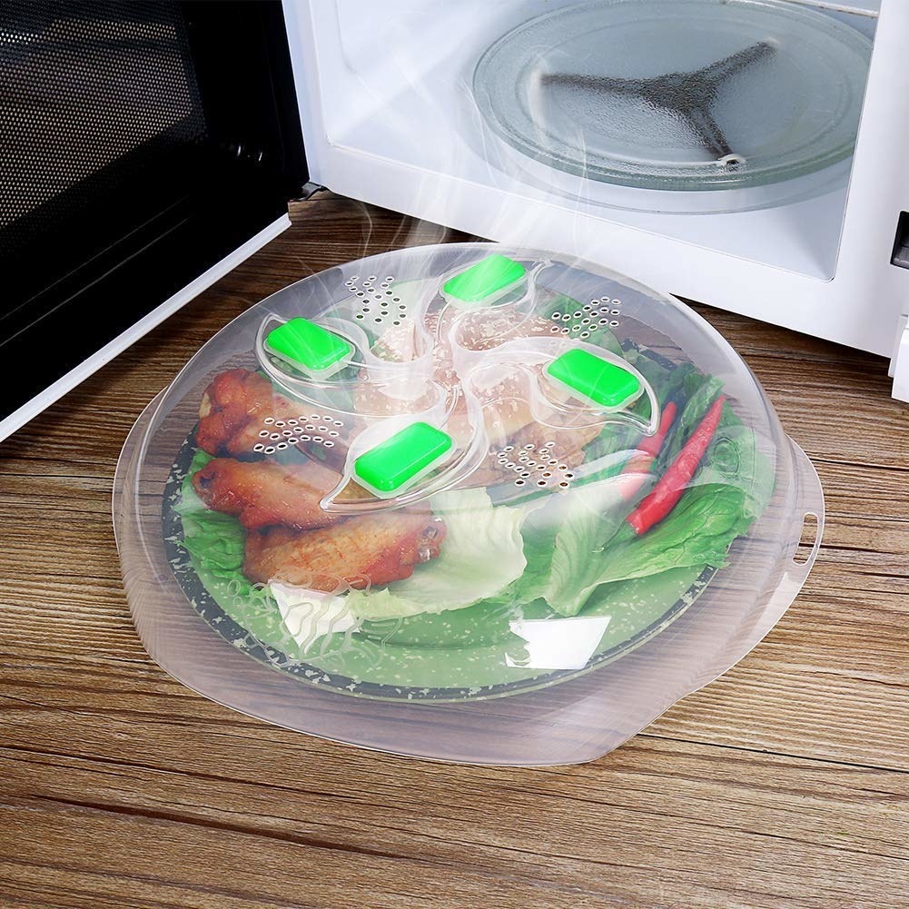 clear dome over a plate in front of a microwave
