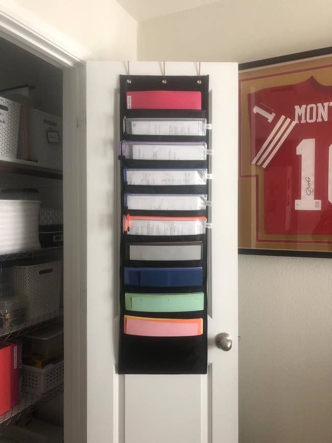 Reviewer photo of the 10-slot organizer hanging from the back of a closet door
