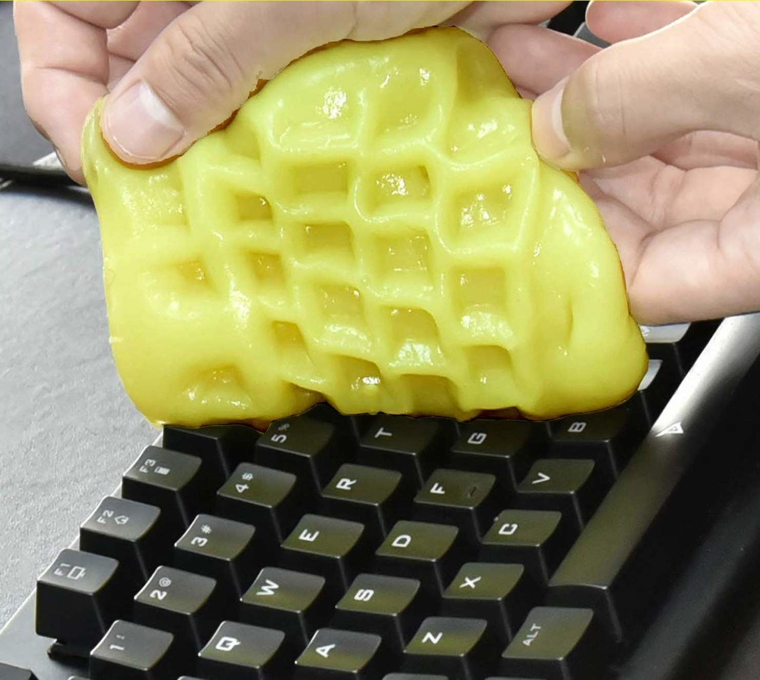 A close up of a person using the goo on a keyboard