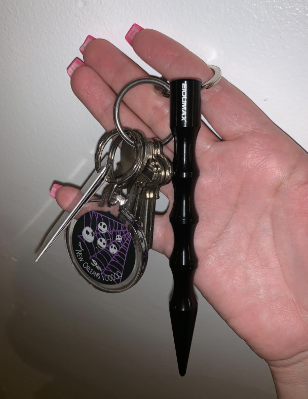 Reviewer shows the self defense keychain with their other keys