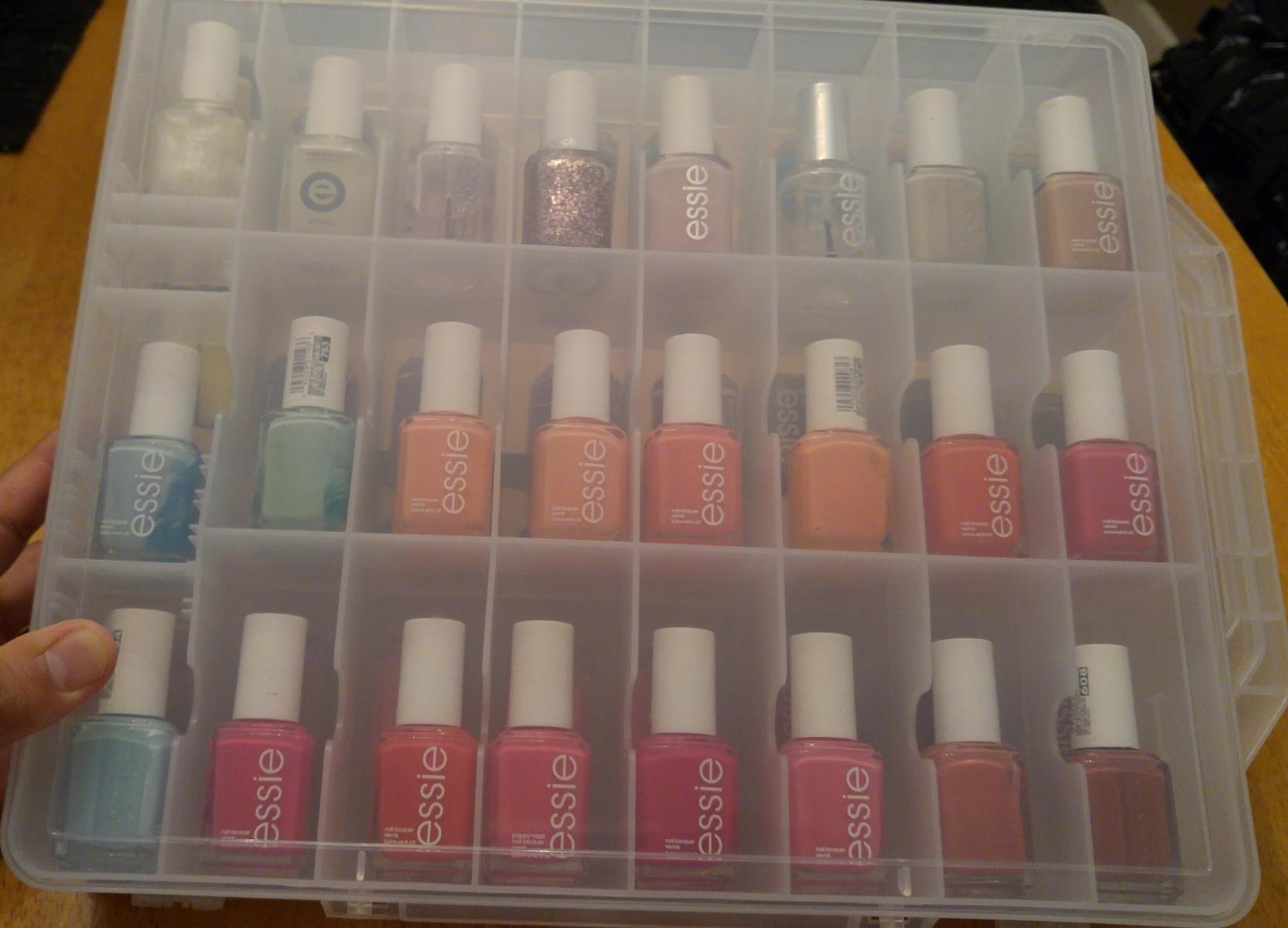 Reviewer photo of the bin filled with a rainbow of assorted nail polish bottles