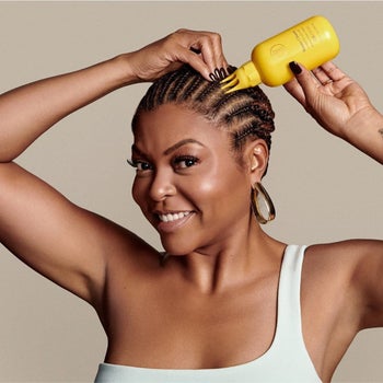 Actress Taraji P. Henson pouring the bottle of scalp conditioner directly to her scalp