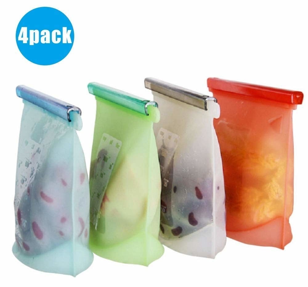 Four reusable silicone bags with food in them in different colours