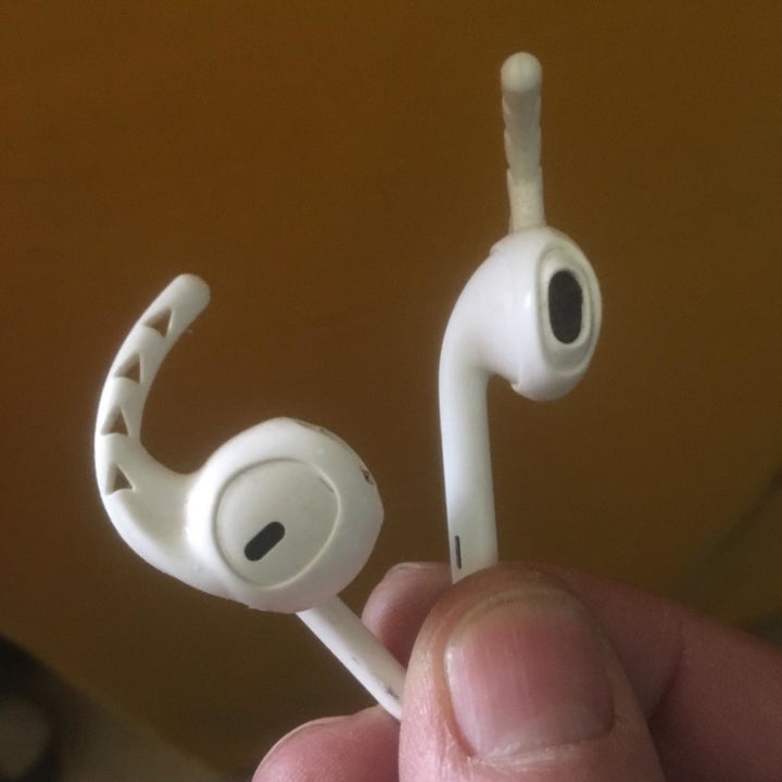 close up of airpods with small white hooks on them 