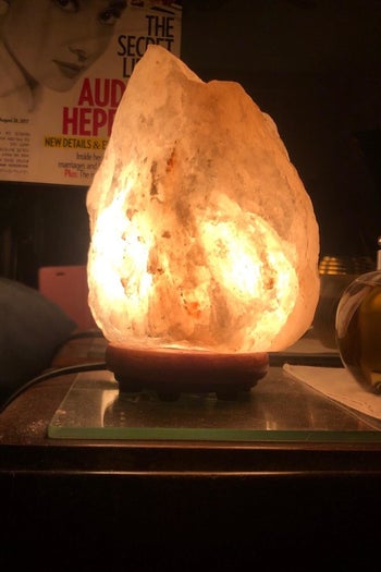 reviewer's salt lamp glowing in a dark room 