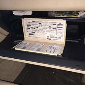 Holder open, showing organized insurance and registration in plastic sleeves