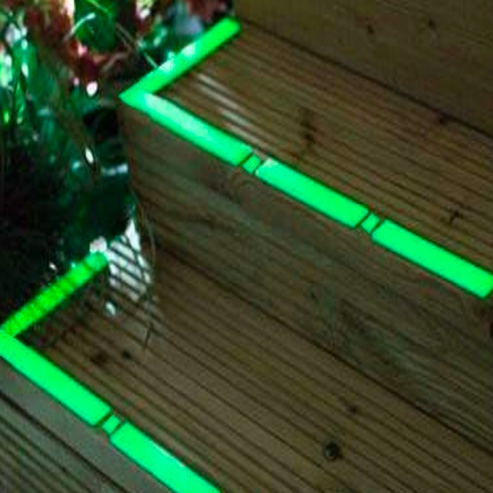 Porch steps covered in bright glowing green tape 