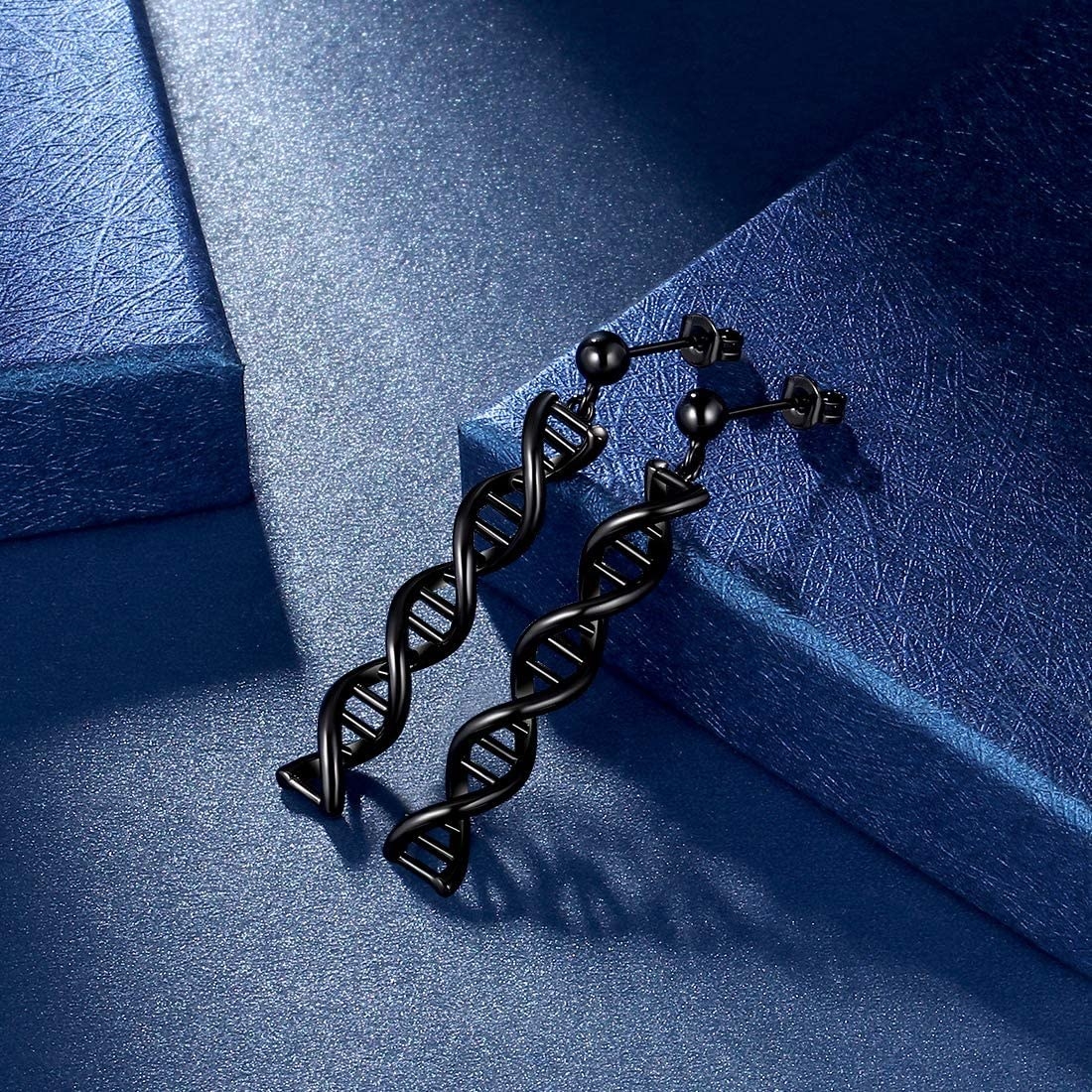 Two earrings shaped like DNA