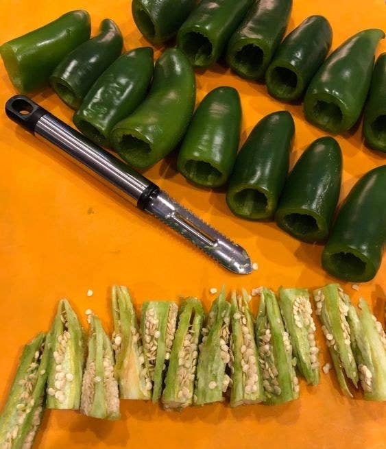 Reviewer image of the jalapeño corer with a number of clean cored jalapeño in the top of the images all of the cores in the bottom of the image