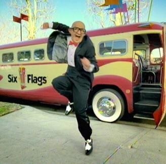 The Six Flags old man dancing in front of a Six Flags bus