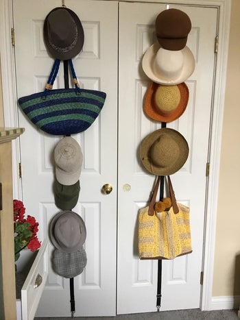 A different reviewer photo of the holder holding different style hats and purses