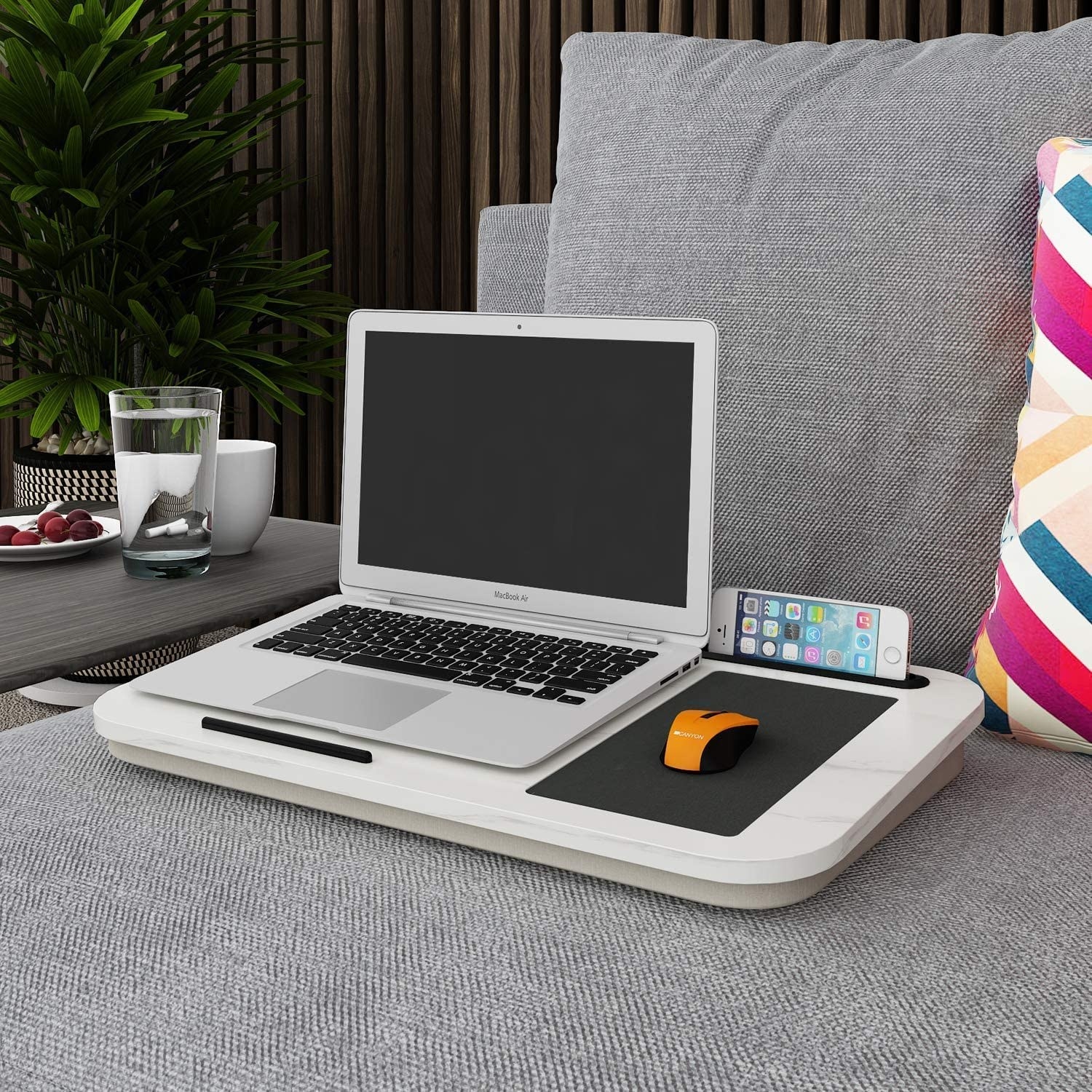 A computer and phone on the marble-topped lap desk
