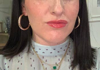 reviewer wearing hoops with polka dot blouse