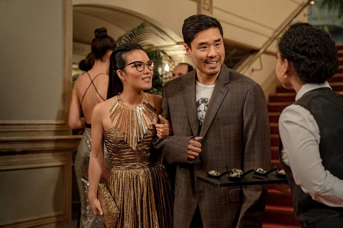 Sasha and Marcus arm in arm at a party