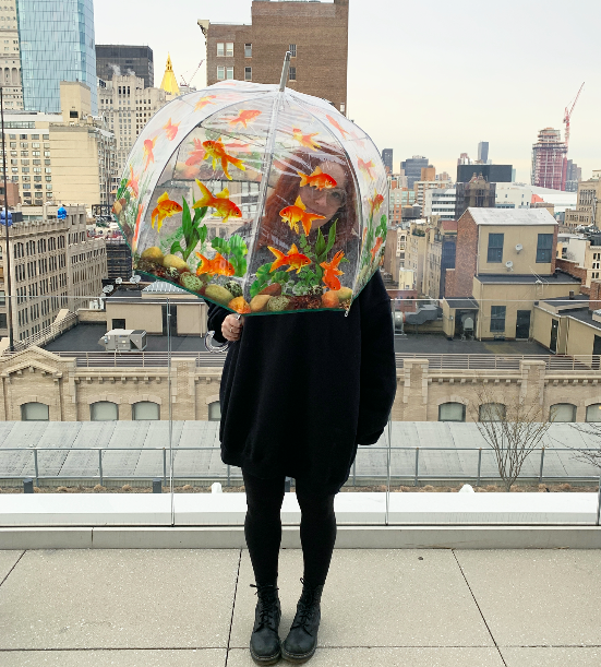 shopping writer mallory mower uses clear round umbrella with fish on it 